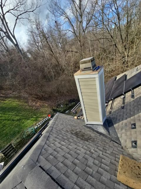 Sided chimney on shingled roof